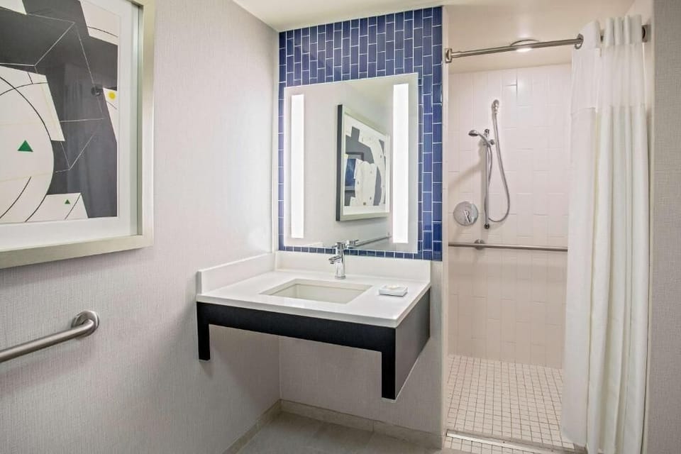Refresh easily in a spotless bath with bright vanity mirror.