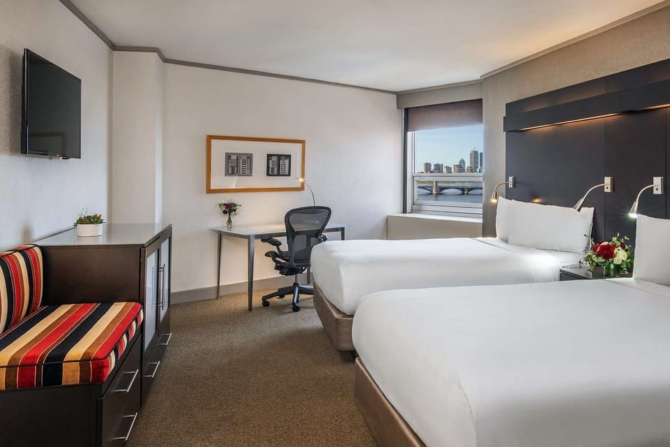 Stretch out comfortably in a modern room with two plush beds.
