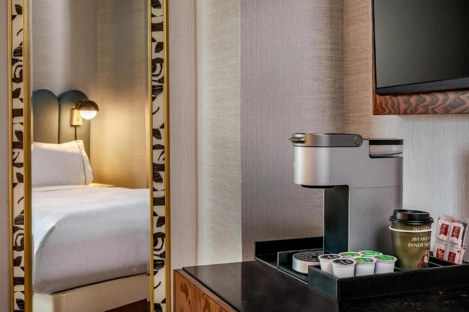 Drift off with soft lighting and fresh bedside florals.