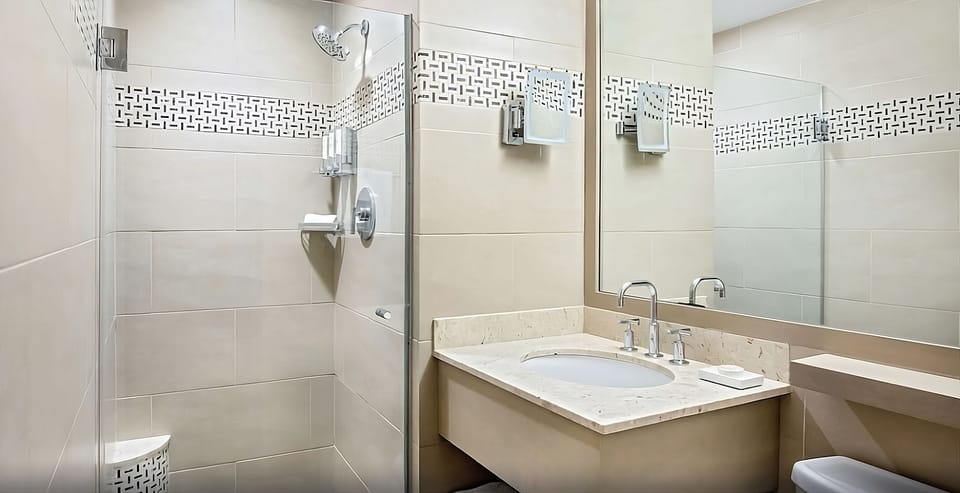 Refresh in a spotless bathroom with a walk-in shower.
