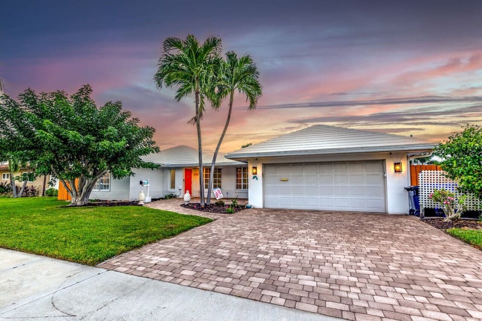 A perfect tropical getaway home with a driveway large enough to accommodate two cars.