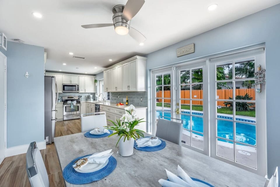 Fully equipped kitchen to prepare meals and ample counter space. The dining area seats four, perfect for family meals or game nights with a mesmerizing view of the pool. The decor is bright and inviting, inspired by the colors of a tropical getaway.