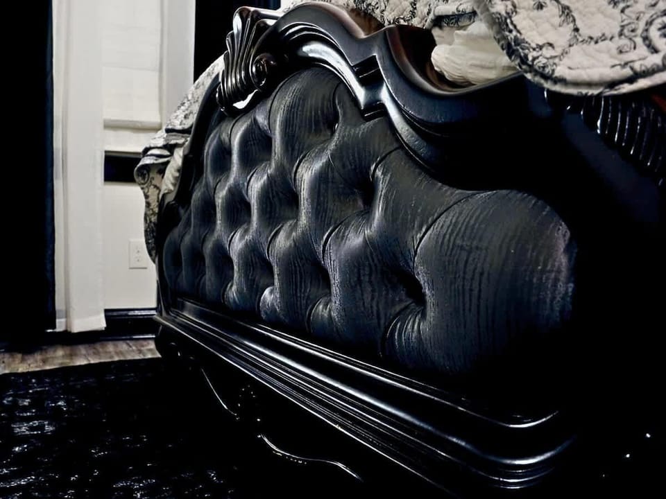 Elegant tufted bedframe detail adds rich texture and timeless character to this Charlotte bedroom. Thoughtful design and dramatic finishes create a refined boutique retreat made for restful nights.