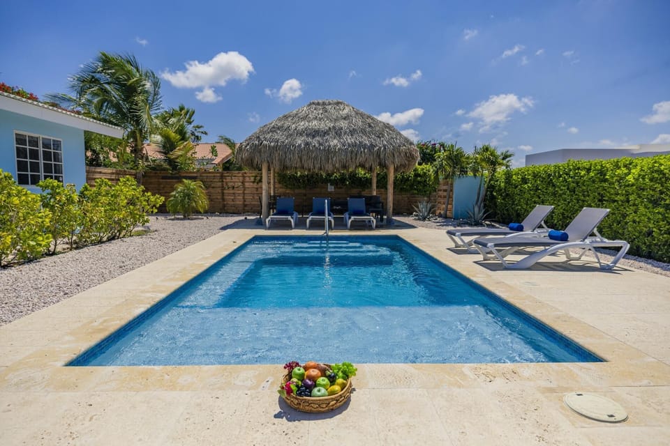 Relax by your private pool just minutes from Eagle Beach—perfect for soaking up the Aruba sunshine.