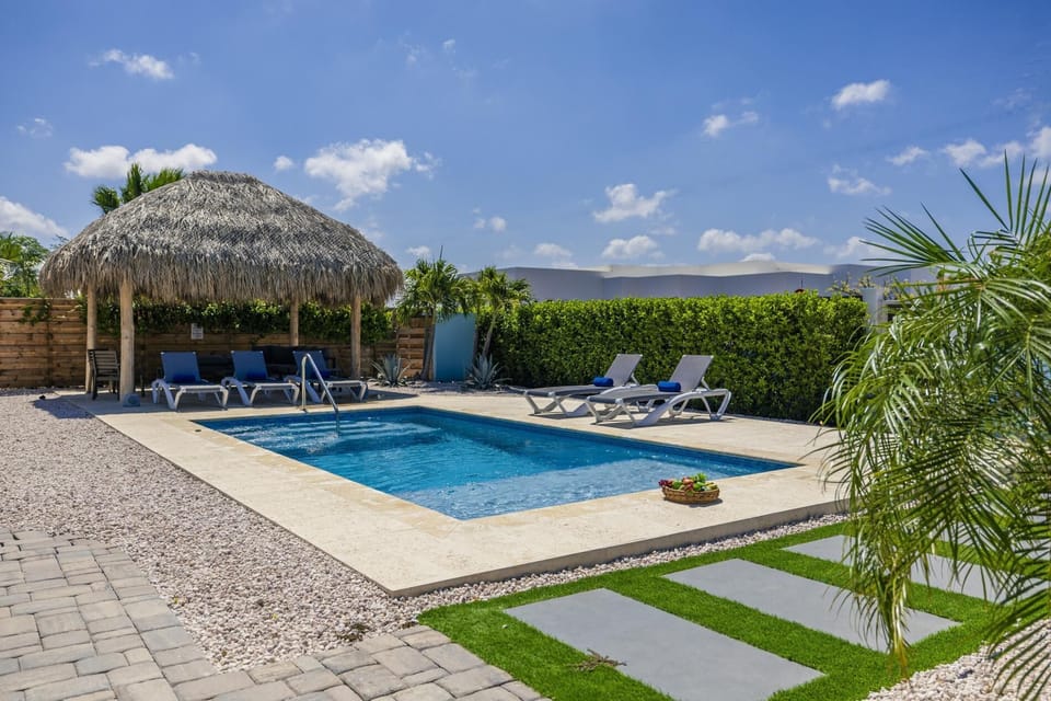 Unwind under the palapa or lounge by the poolside in this tropical outdoor retreat.