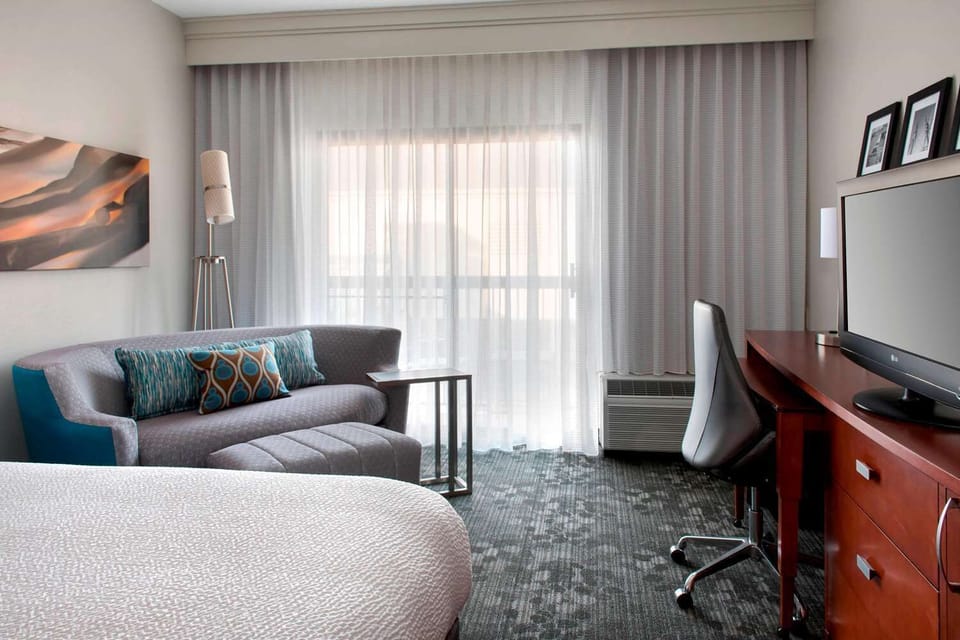 Settle in by the window with lounge seating and desk.