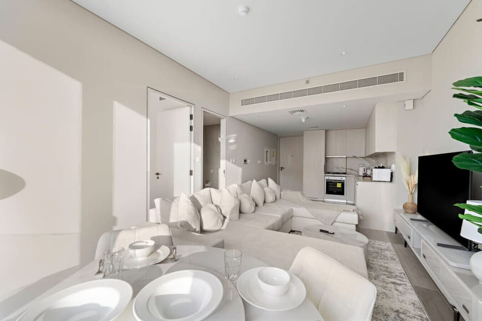 Living Room: Bright and inviting space with plush seating and a sleek kitchen for your culinary adventures!