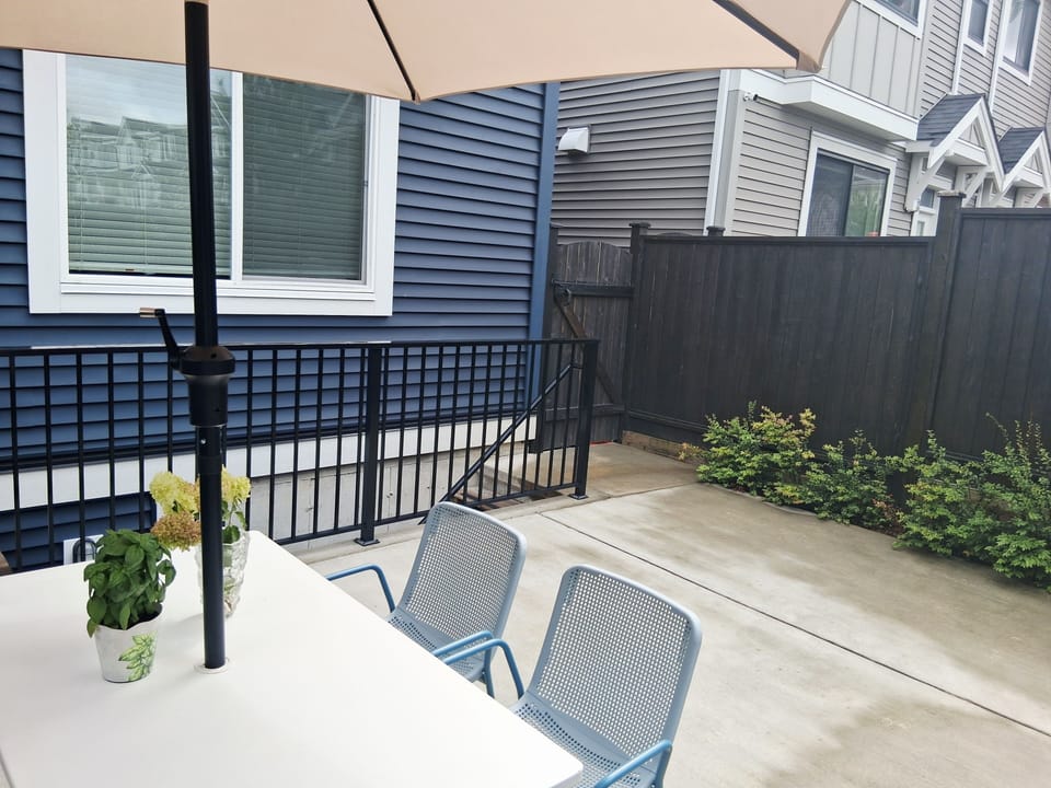 fence, handrail, staircase, terrace patio, property entrance, dining table