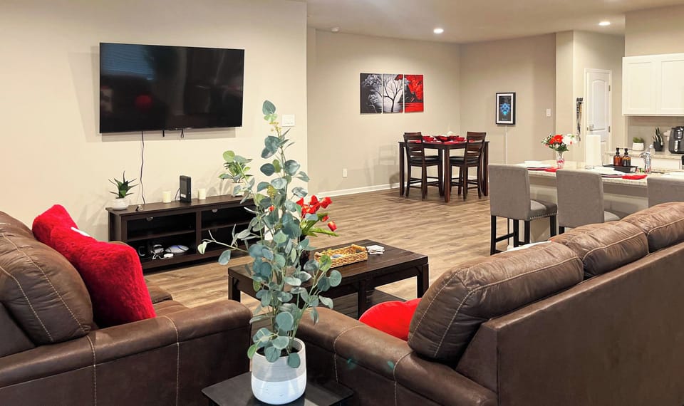 The spacious living area provides comfortable seating on Ashley fabric furniture to enjoy your favorite shows on our 65" 4K TCL ROKU Smart TV. 