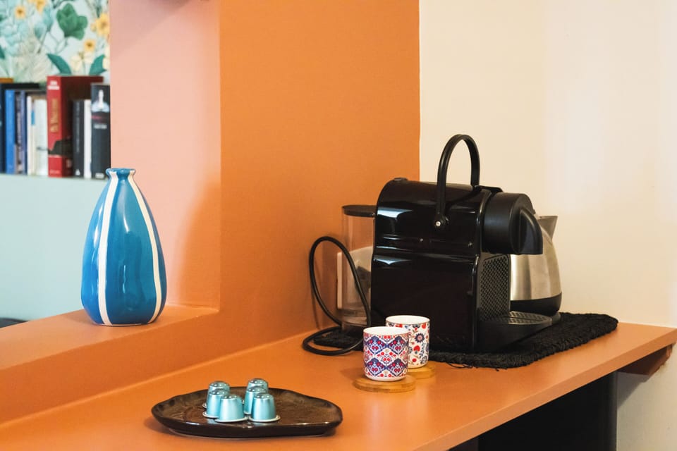 Nespresso coffee maker and hot water kettle.