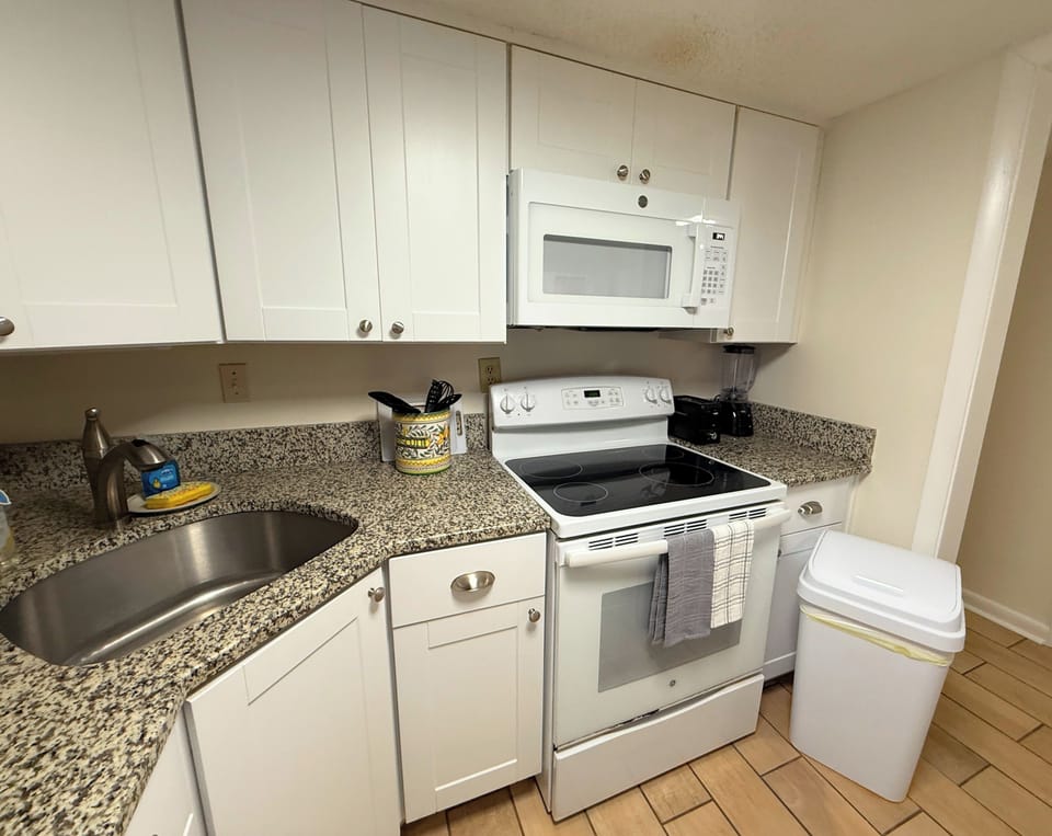 Updated kitchen with stove/oven, microwave, blender and toaster.