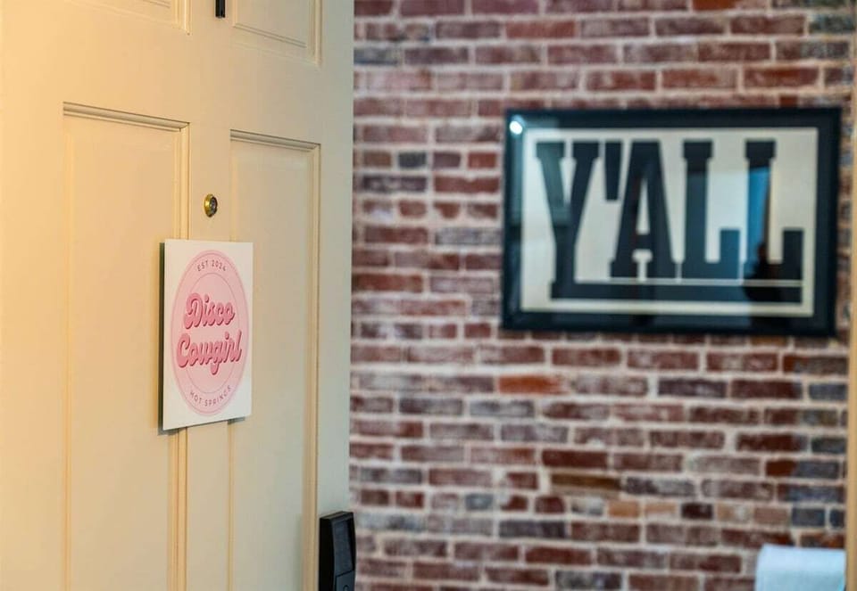 A fun “Y'all” sign adds a welcoming Southern touch to the decor, capturing the essence of this unique downtown loft.