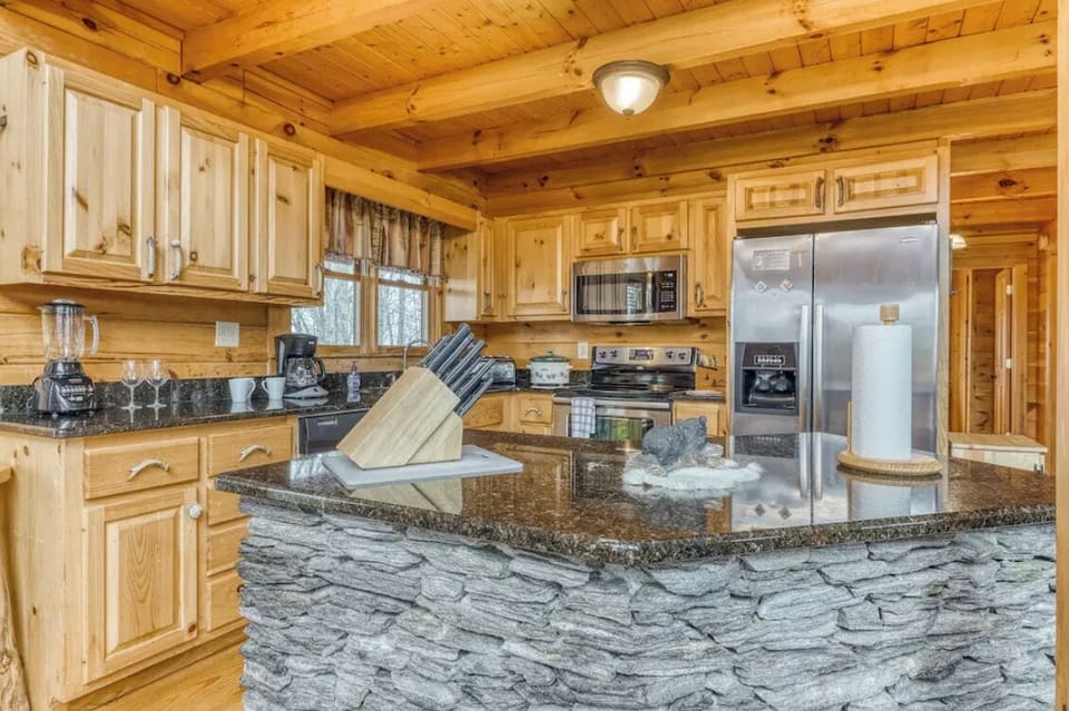 Stocked kitchen with stainless steel appliances ready for multiple families to cook a meal.