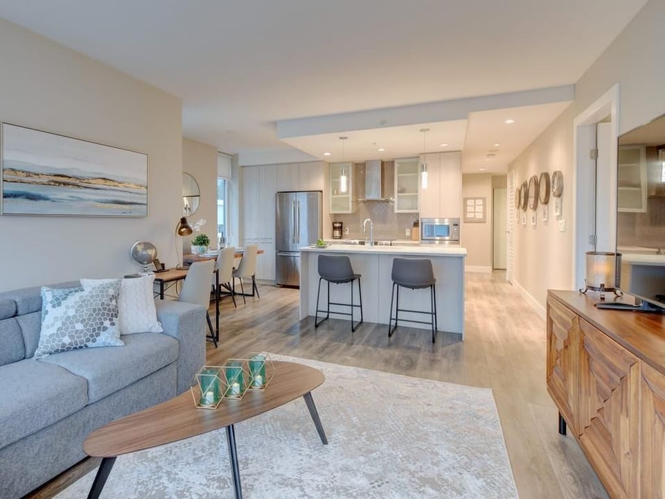 Open living room with a glimpse modern kitchen