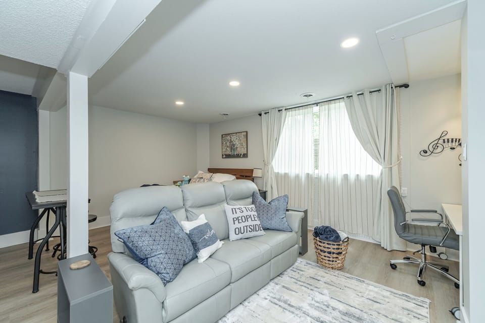 leather recliner couch facing the electric fireplace and 65" TV