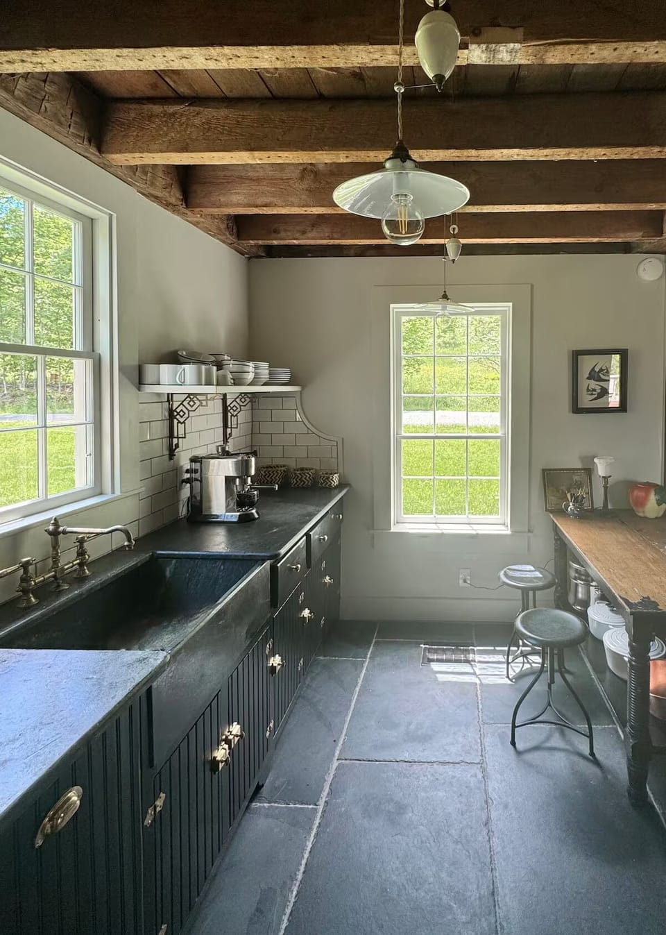 Exposed hand-hewn beams, flagstone floor, soapstone countertop and sink