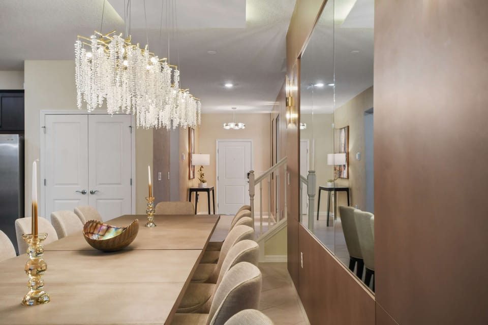 Elegant dining area with crystal chandeliers and mirrored accents.