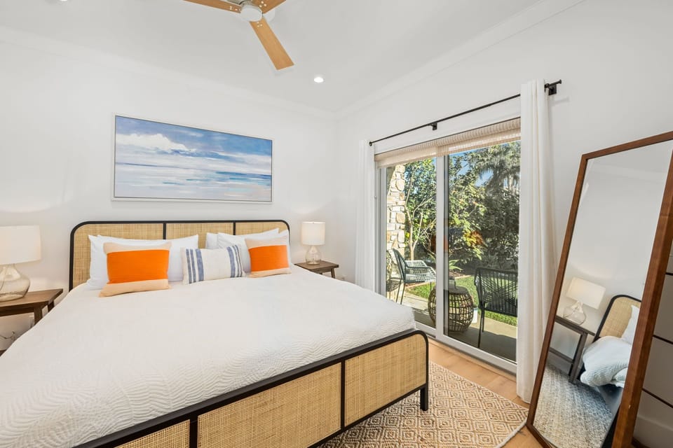 After entering the home, double french doors open to the 1st floor bedroom, complete with a comfortable new king-sized bed, luxury crisp white bedding, a full-length mirror, and private sliding door which opens to the front patio.