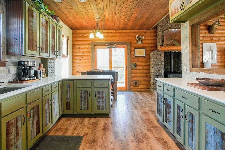 Spacious kitchen with a warm wood ceiling and convenient layout, offering a seamless connection to the dining and living areas.