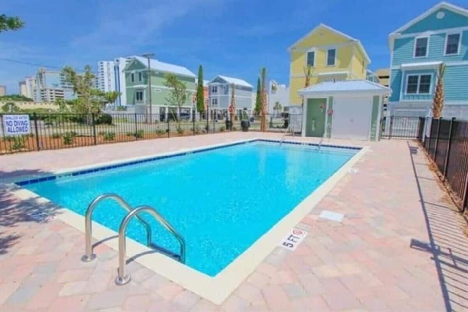 Serene poolside retreat with ample lounge space and sunny surroundings