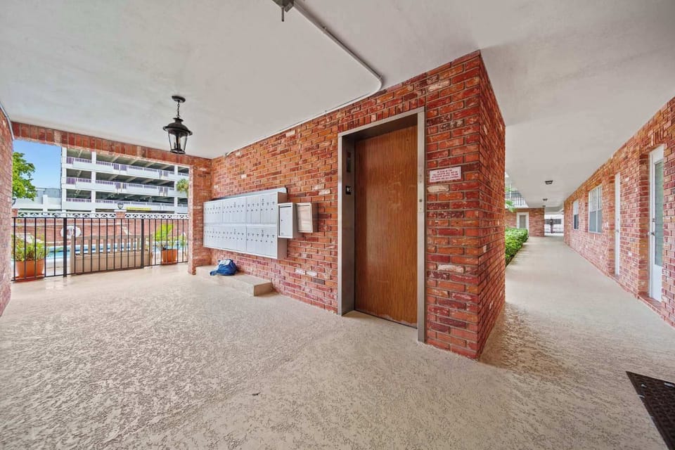 Convenient access with elevator and pool view in this charming brick hallway.
