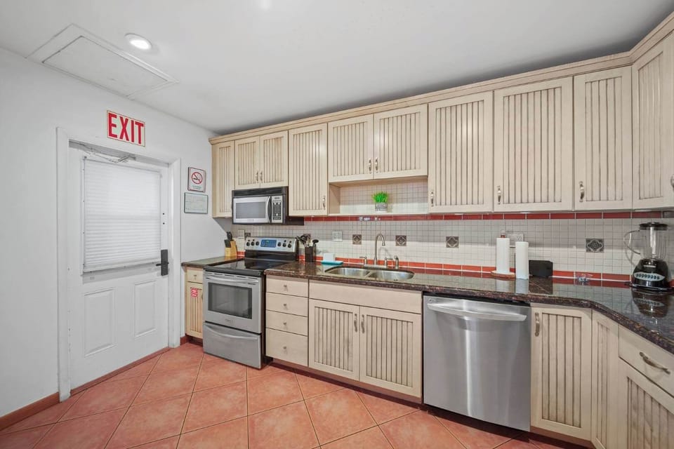 Modern kitchen with stainless steel appliances and ample storage, perfect for cooking up a feast during your stay.