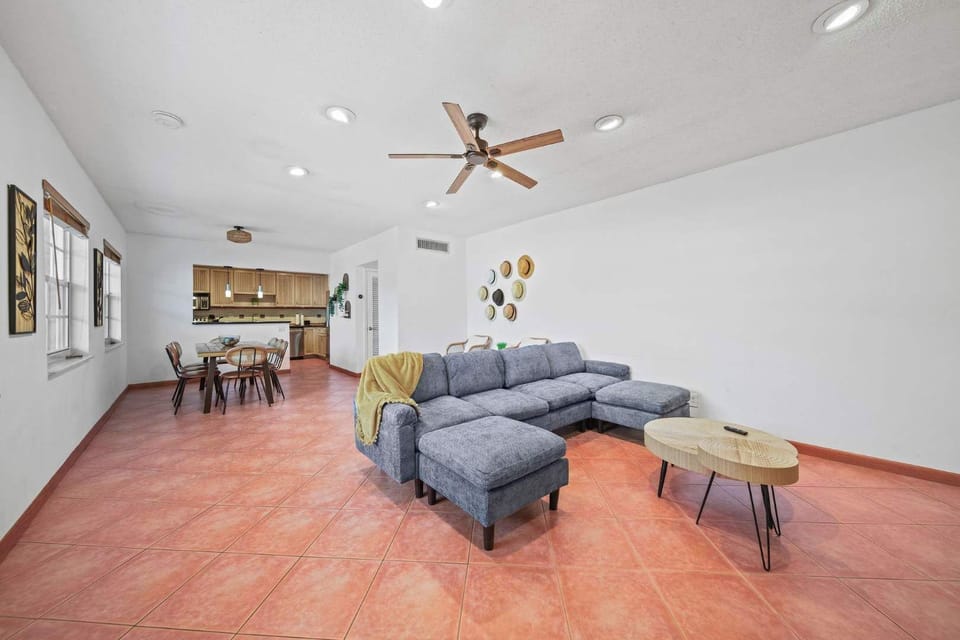 Relax in this spacious living room featuring a cozy sectional sofa and open layout, perfect for gatherings and relaxation.