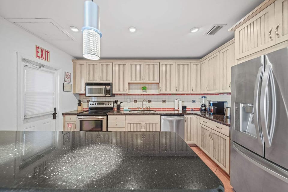 Modern kitchen with sleek appliances and ample counter space, perfect for culinary adventures.