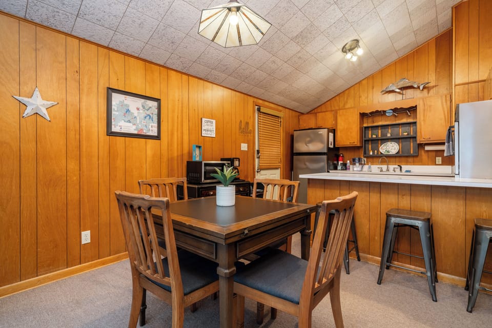 The mid-century table extends to seat 6 and the bar seats 3.