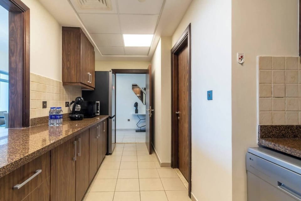 A stylish kitchen features all the modern appliances for food storage and preparation. It is ideal for short and long-term stays.