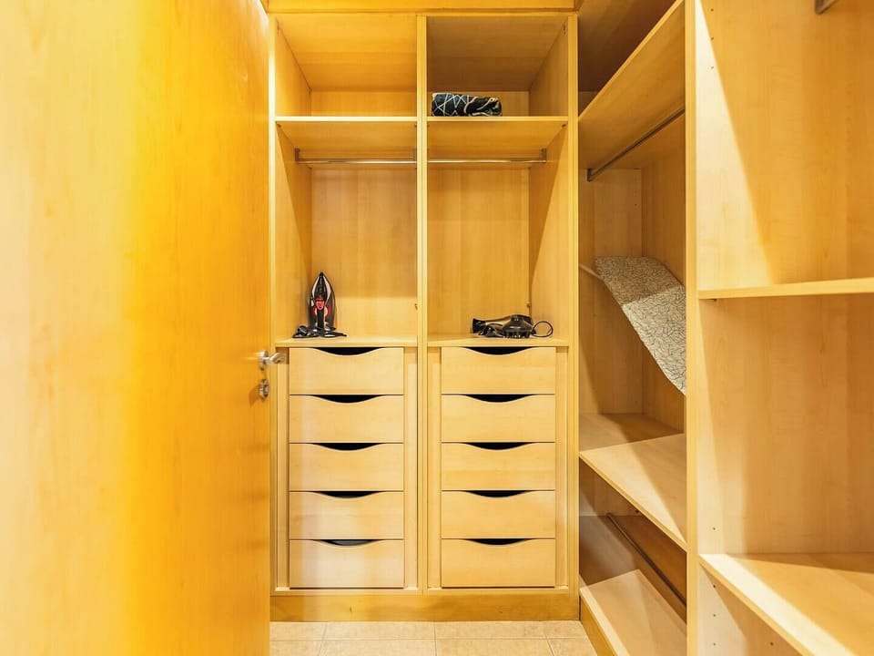 Keep your belongings organized with this spacious walk-in closet, offering ample storage for your stay.