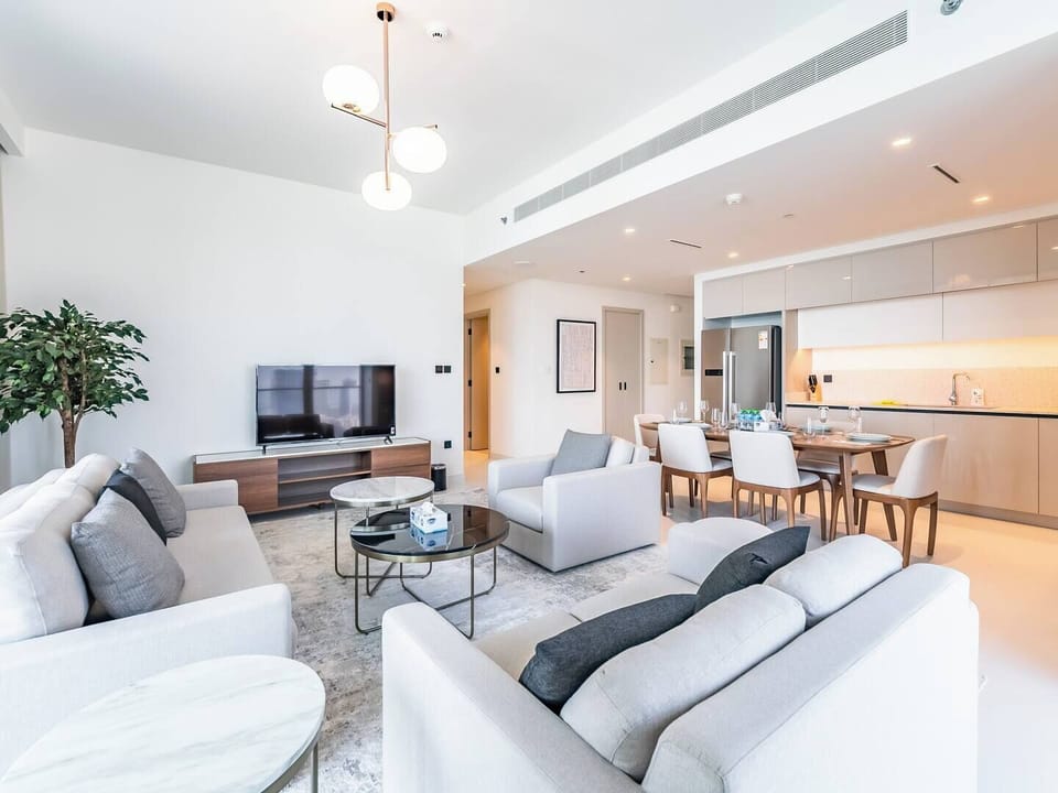 Enjoy the spacious, sunlit living room with contemporary décor and a comfortable seating arrangement, perfect for relaxation.