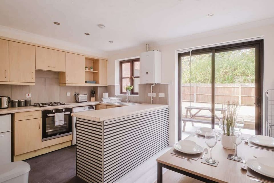 The sleek kitchen offers all the amenities you need, featuring a dining table and seating for a relaxed dining experience