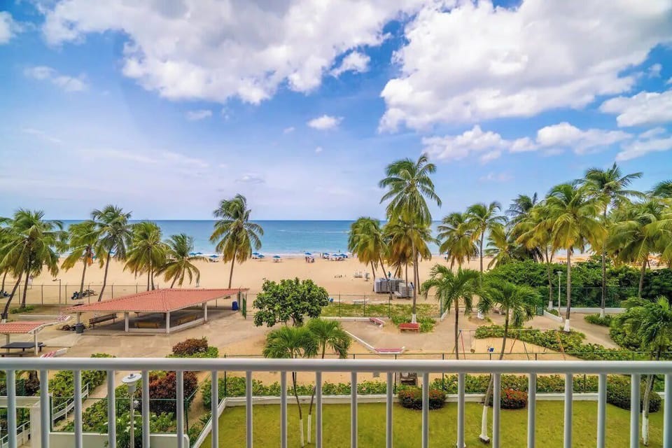 Breathtaking oceanfront vibes and swaying palms from your private balcony just steps away from Isla Verde Beach.