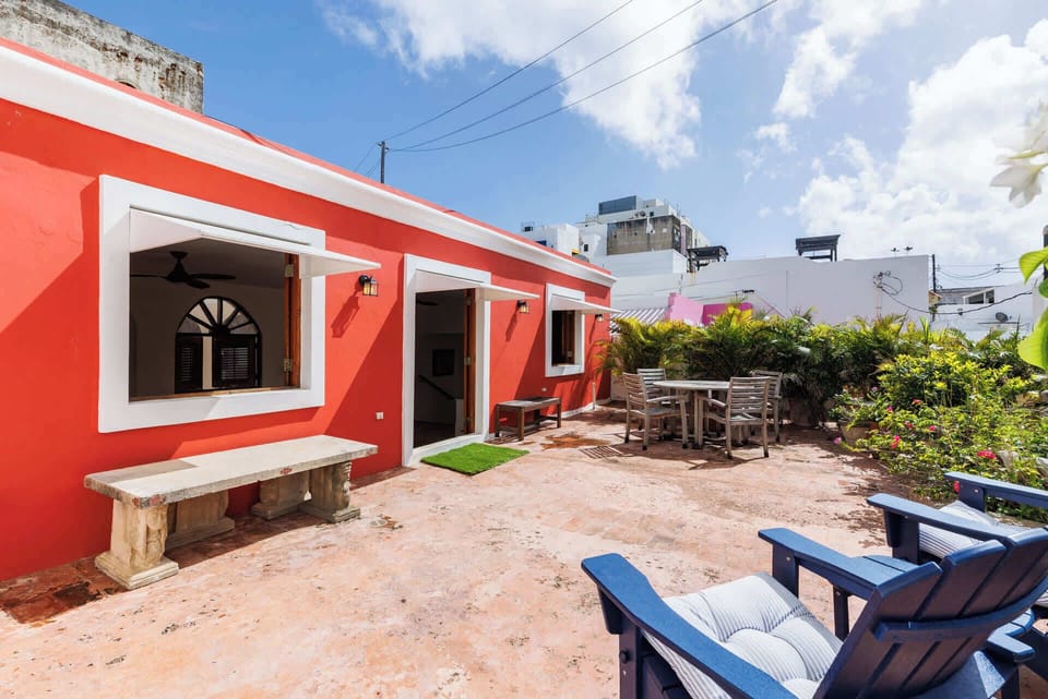 Sunny private terrace with lush greenery and outdoor seating — perfect for morning coffee, al fresco dining, or soaking in the charm of Old San Juan.
