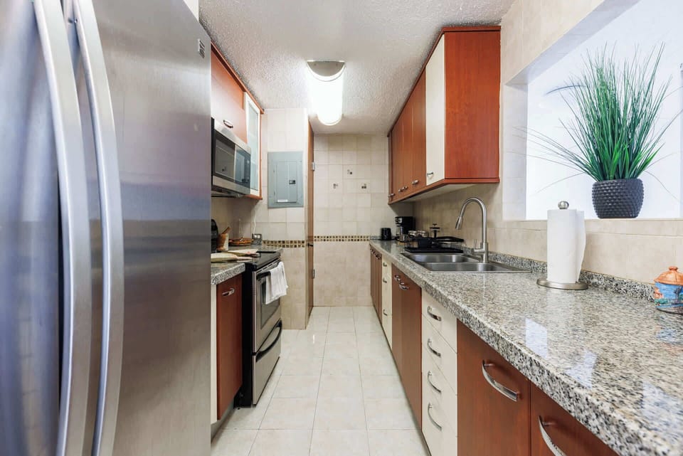 Fully equipped kitchen featuring stainless steel appliances, granite countertops, and modern cabinetry — perfect for preparing meals and enjoying your stay in comfort.