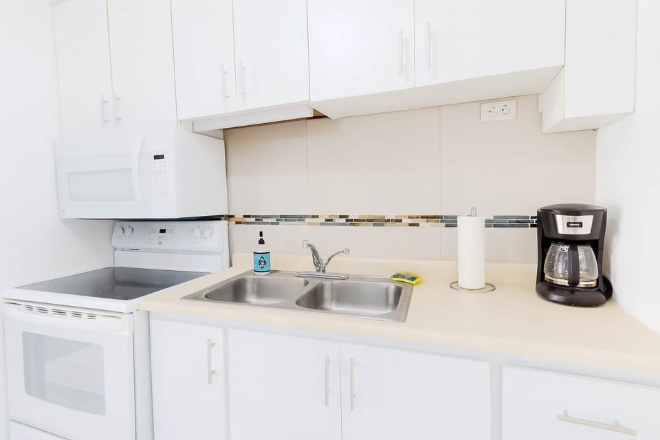 Bright and spotless kitchen with modern appliances — ideal for cooking light meals and enjoying your morning coffee with ease.
