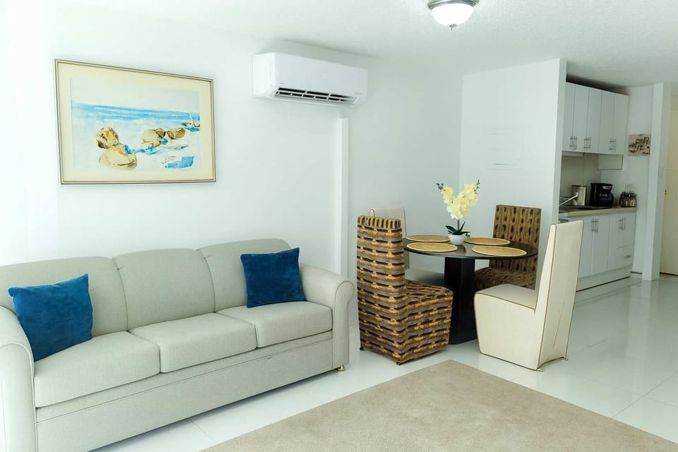 Open and inviting living space with modern décor, comfortable seating, and a cozy dining area — perfect for relaxing after a sunny day in Isla Verde.