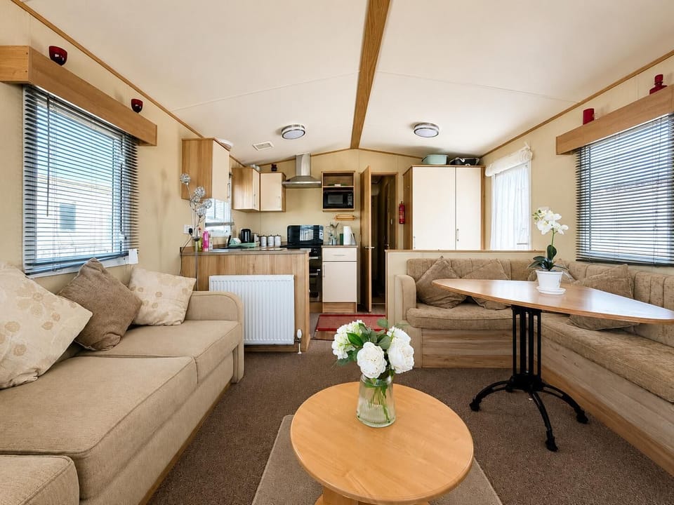 The holiday home living room is designed with comfort in mind, featuring a fireplace.
