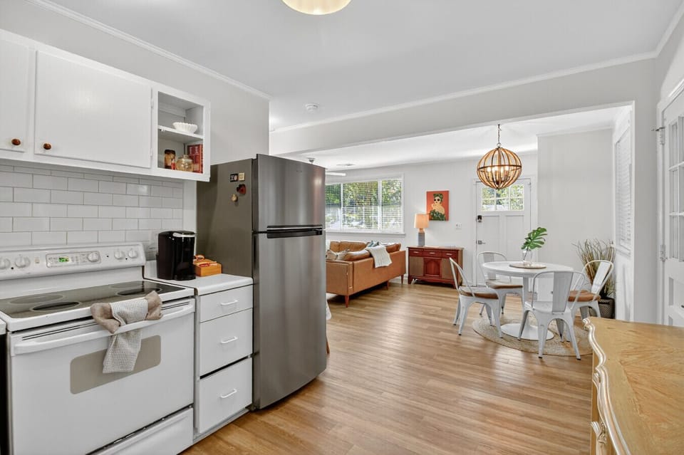 Cook, dine, and relax with ease — this open kitchen and living area makes time together effortless and comfortable.