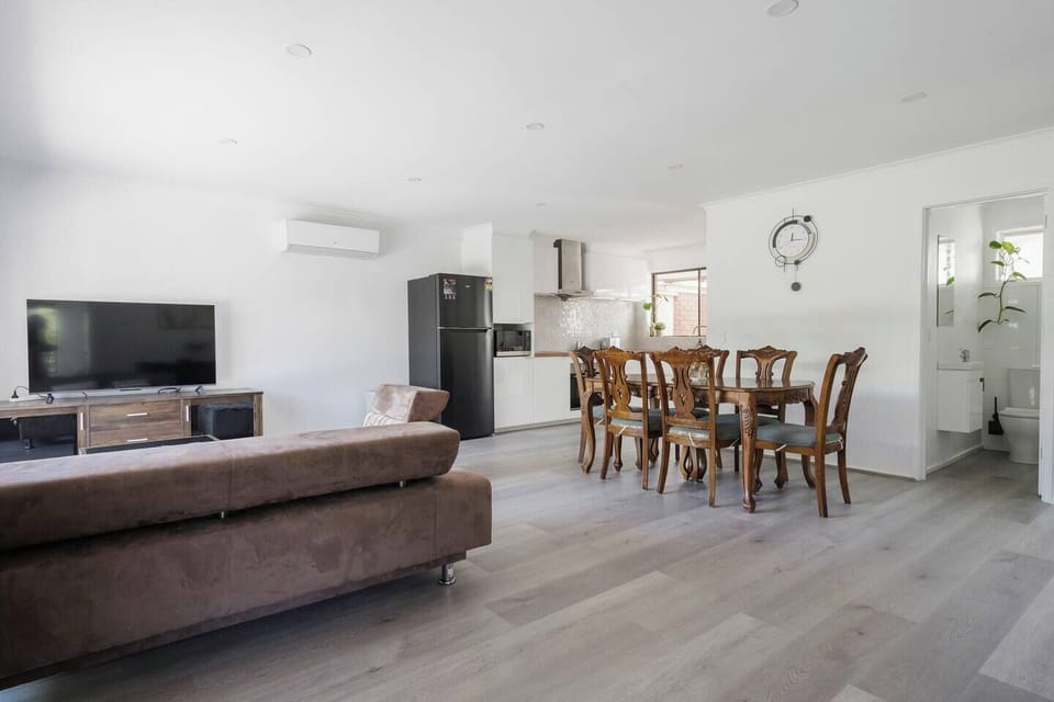 Open-plan living area seamlessly connecting the dining and kitchen spaces, ideal for family gatherings.
