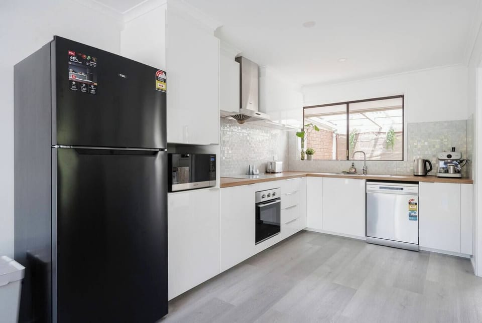 Modern kitchen with stainless steel appliances, ample counter space, and a seamless flow to the dining area.
