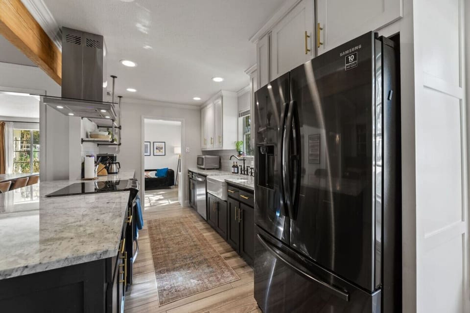 Featuring a stove, oven, fridge, and all the essentials, this kitchen is perfect for home-cooked meals or quick snacks.