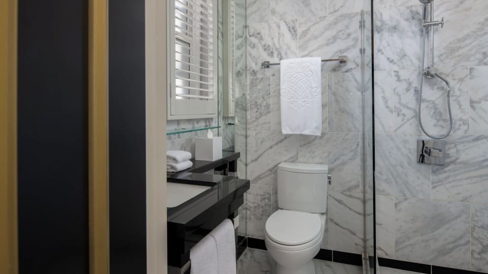 Refresh in a marble bathroom with a glass walk-in shower.