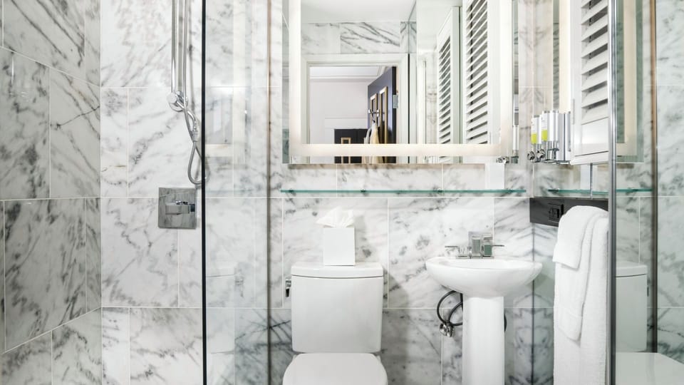 Refresh in a marble-bright bathroom with spa-like serenity.