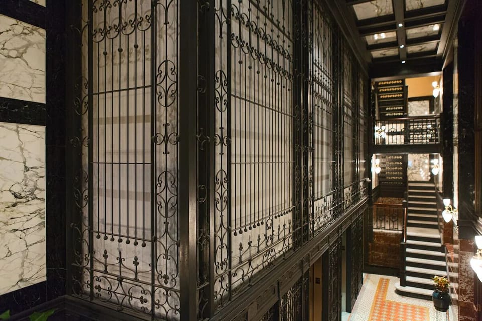 Step into a dramatic corridor lined with vintage ironwork.