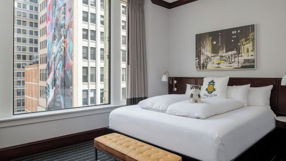 Unwind in crisp linens with dramatic city mural views.