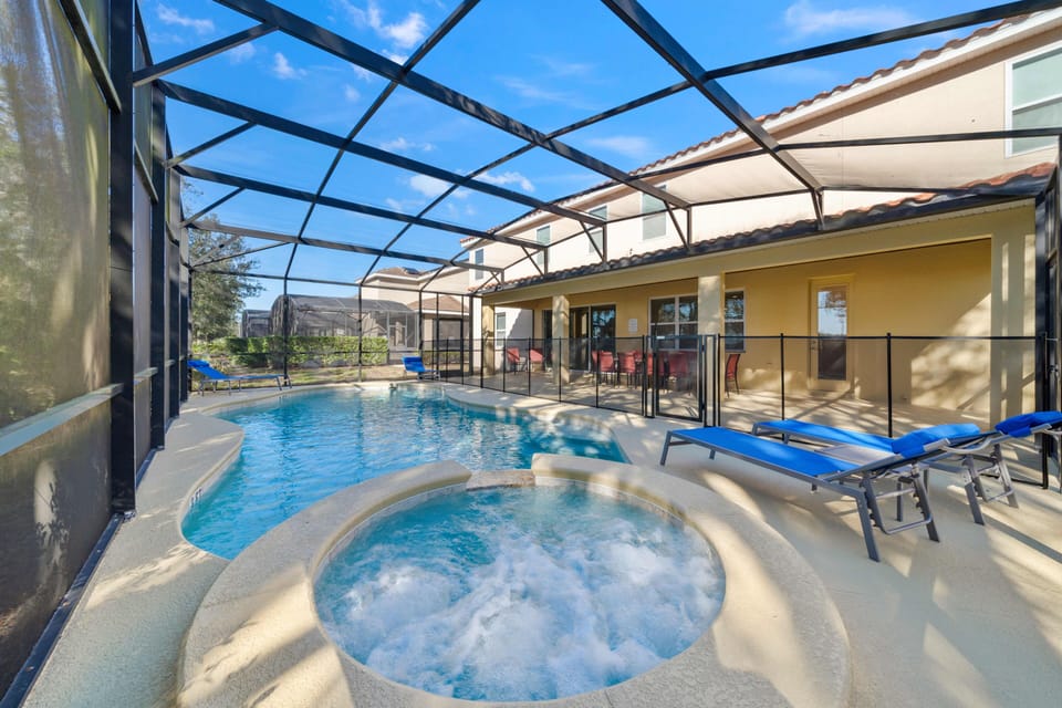 - Private screened pool and spa with outdoor loungers  
- Covered patio with dining area for group gatherings  
- Orlando vacation rental with pool and hot tub retreat