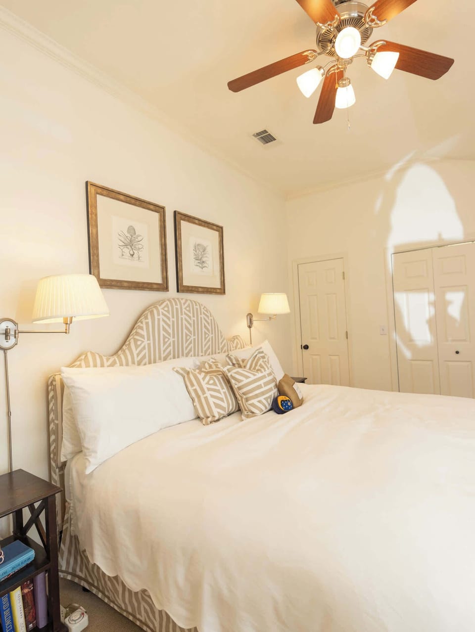 A corner view of a sunlit bedroom showing the high ceilings and clean architectural lines.