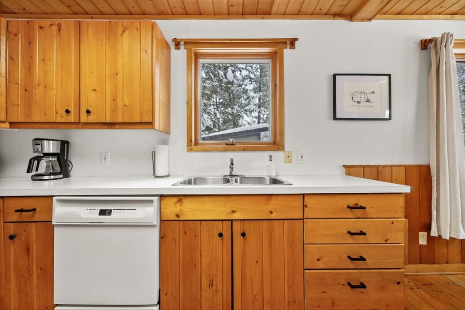 Full kitchen with a drip & espresso coffee machine and a kettle.